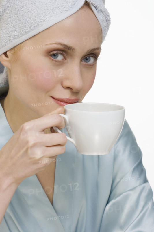 Woman in bathrobe with coffee cup.