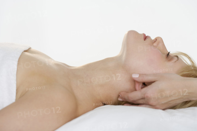 Headshot of woman getting massaged.