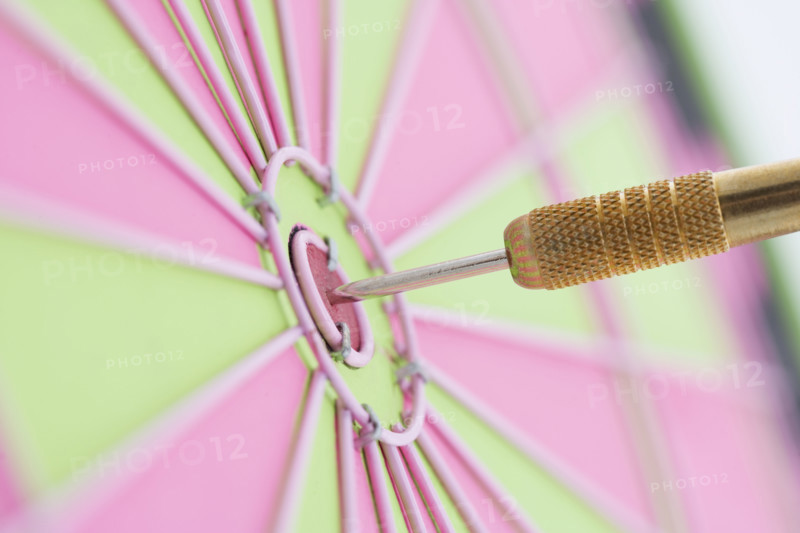 Closeup of dart in bulls eye.
