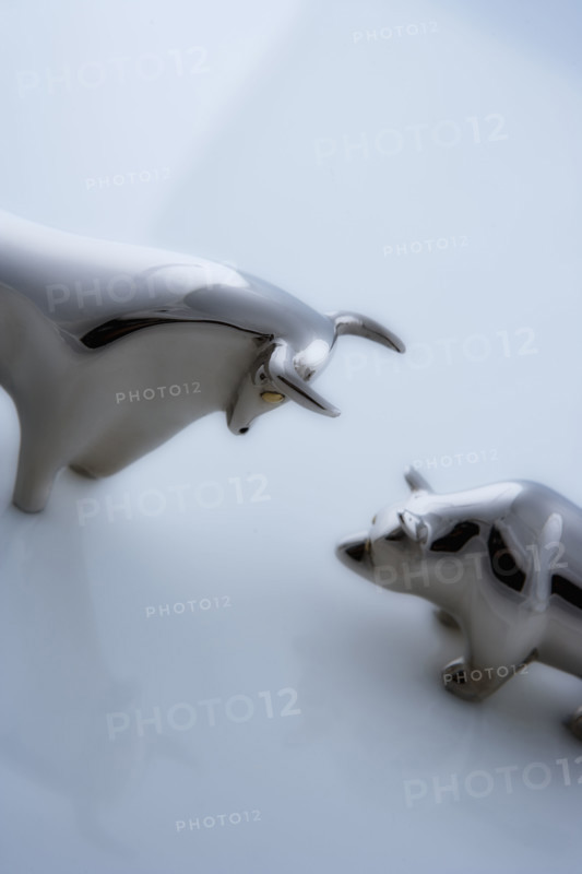 Bull and bear figurines facing-off.