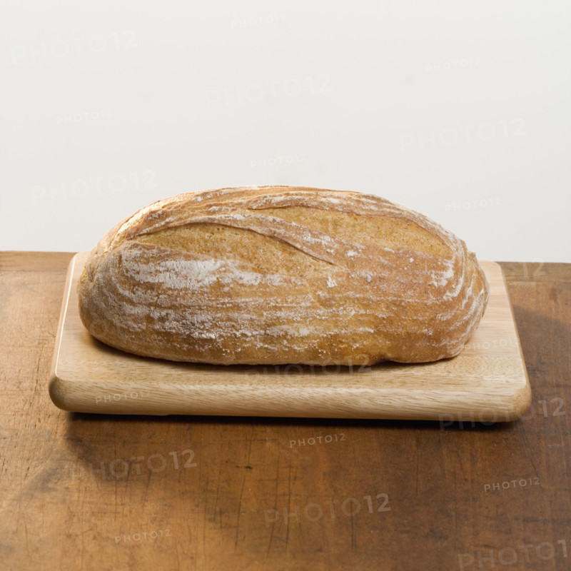 Loaf of bread on cutting board.