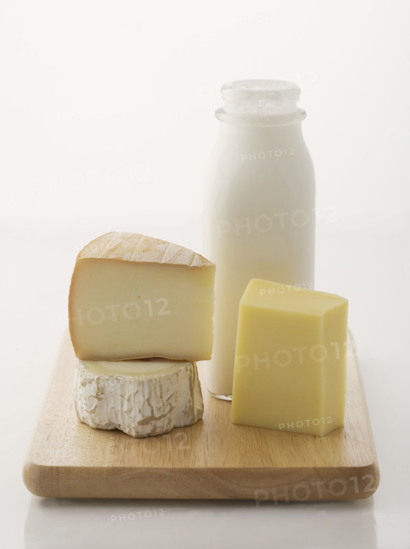 Cheese and milk on cutting board.