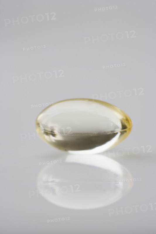 One gelcap and its reflection.
