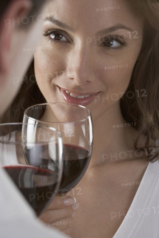 Couple holding wine glasses.