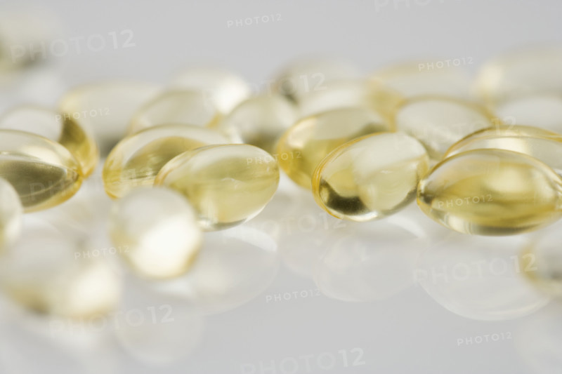 Closeup of several yellow gelcaps.