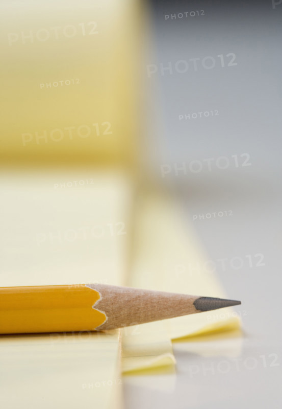Sharpened pencil on pad of paper.