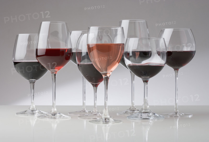Many glasses of different red wines.
