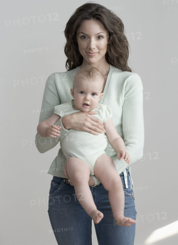 Standing woman holding baby.