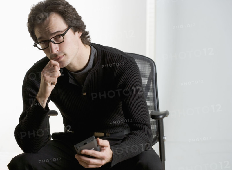 Professional man sitting thoughtfully.