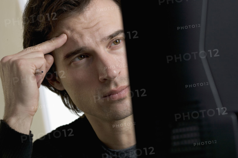 Closeup of man concentrating at computer.