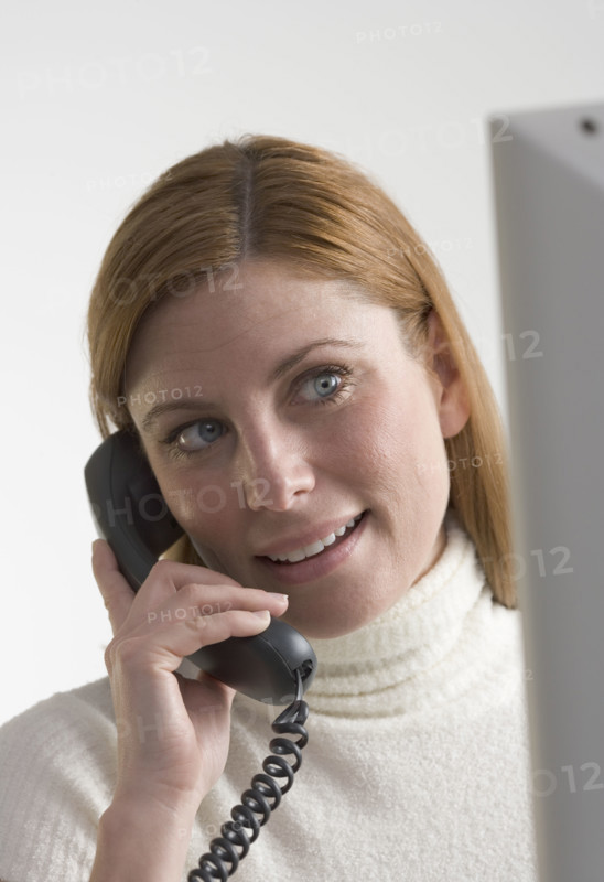 Woman on telephone with computer.