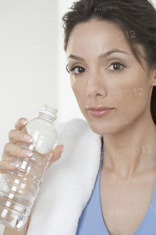 Woman with towel and water bottle.