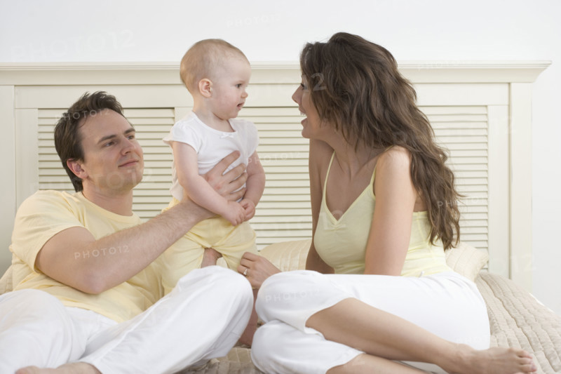 Mom talking to baby with dad.