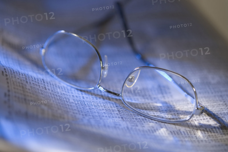 Still life of reading glasses and documents.