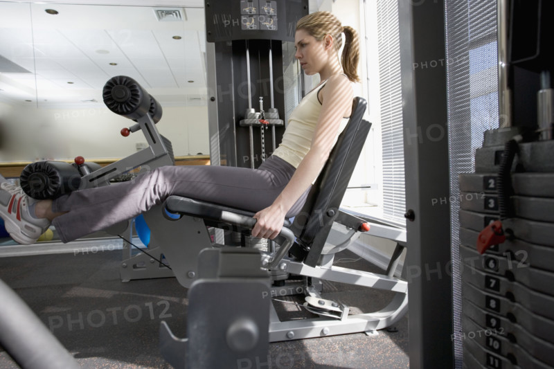 Woman working with resistance machine.