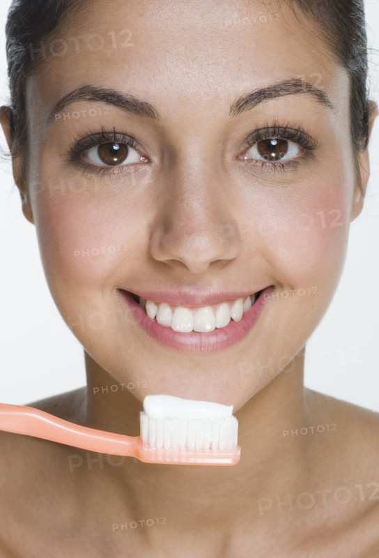 Smiling woman with toothbrush.