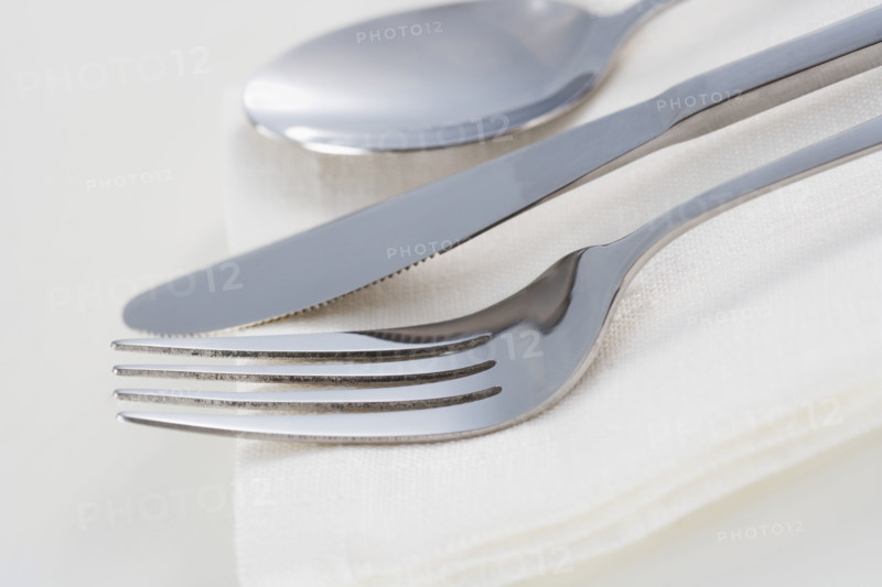 Still life of silverware and napkin.