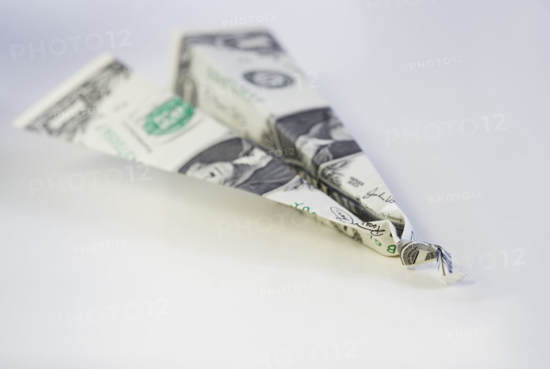 Still life of airplane made from dollar bill.