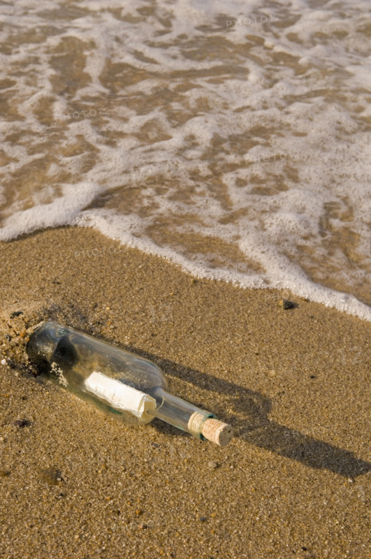 Message in a bottle on beach.