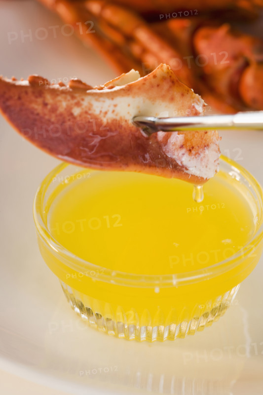 Dipping lobster in melted butter.