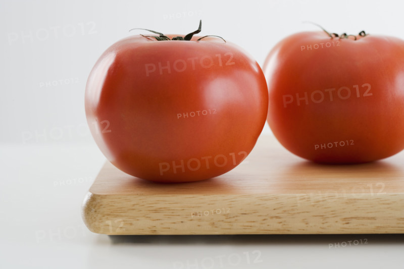 Tomatoes on cutting board.