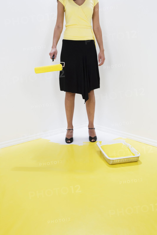 Woman painting herself into a corner.