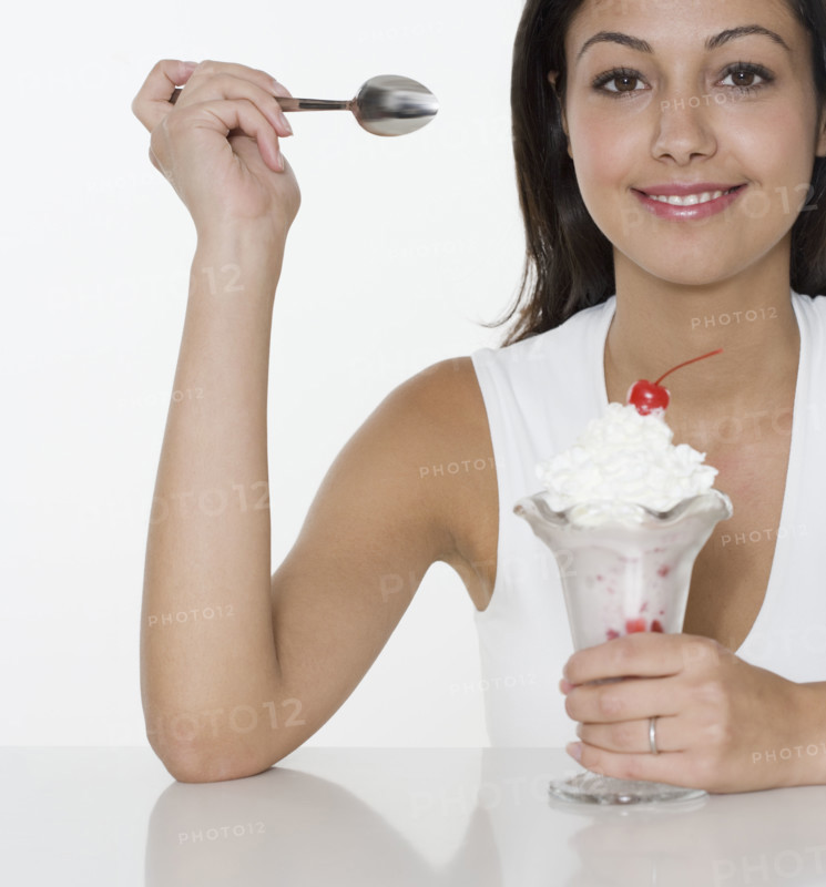 Smiling woman with ice cream sundae.