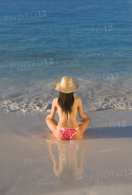 Woman sitting on beach.