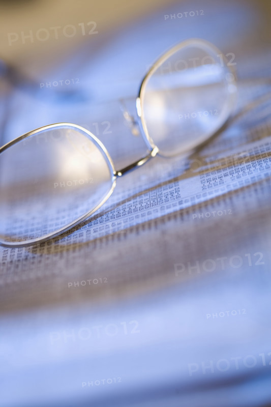 Still life of reading glasses and documents.