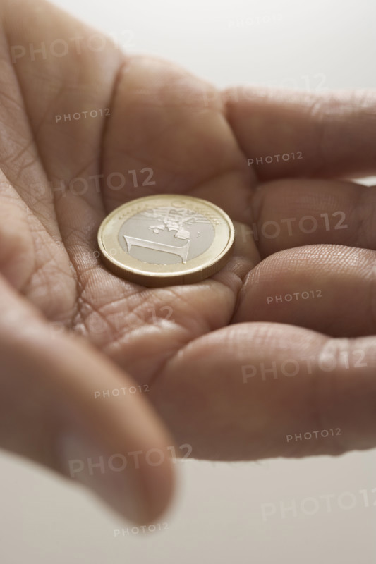 Closeup of Euro coin in palm.