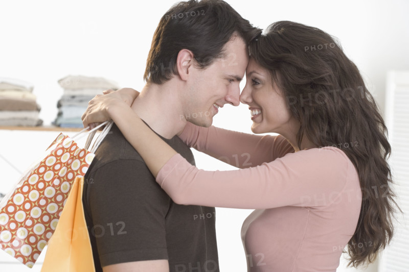 Couple embracing with foreheads touching.