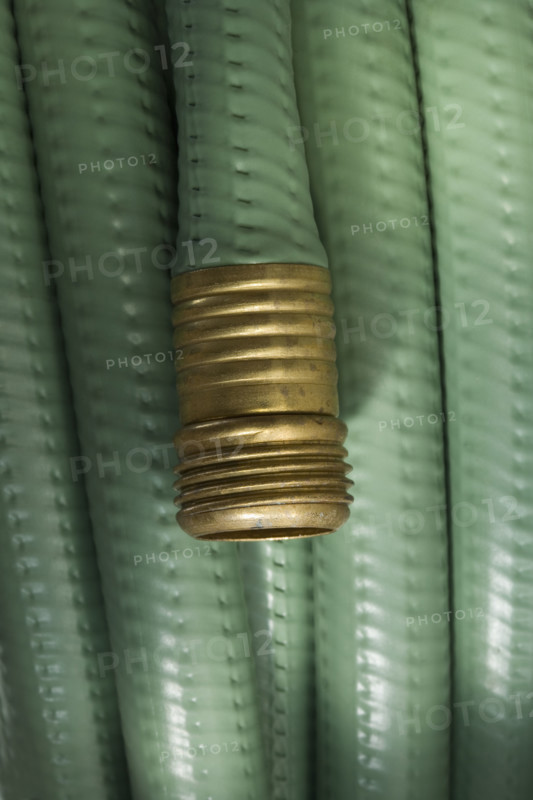 Closeup of wound up garden hose.