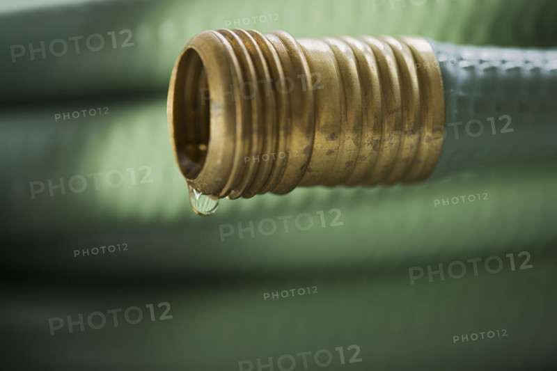Closeup of wound up garden hose.