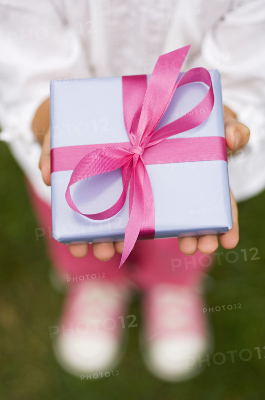Closeup of a present in a childs hands.