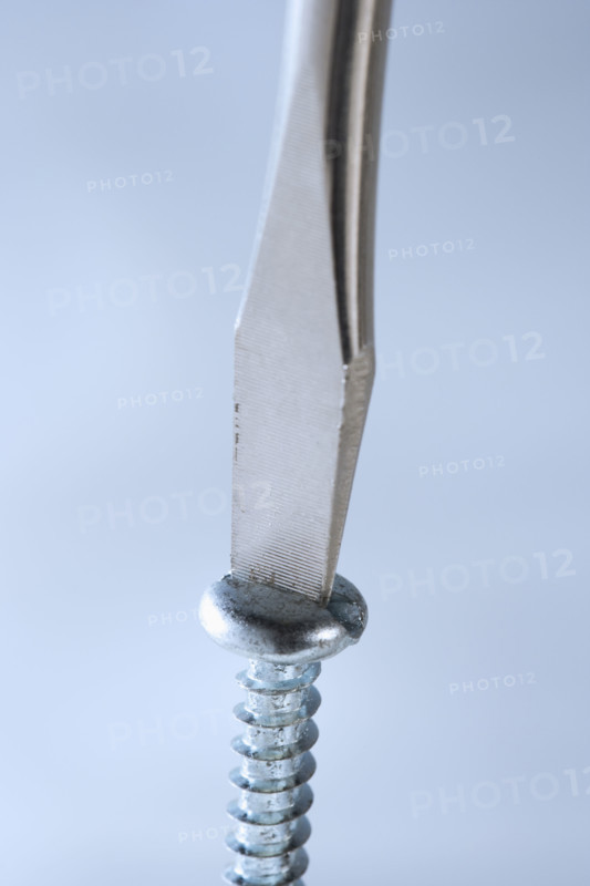 Closeup of screwdriver and screw.