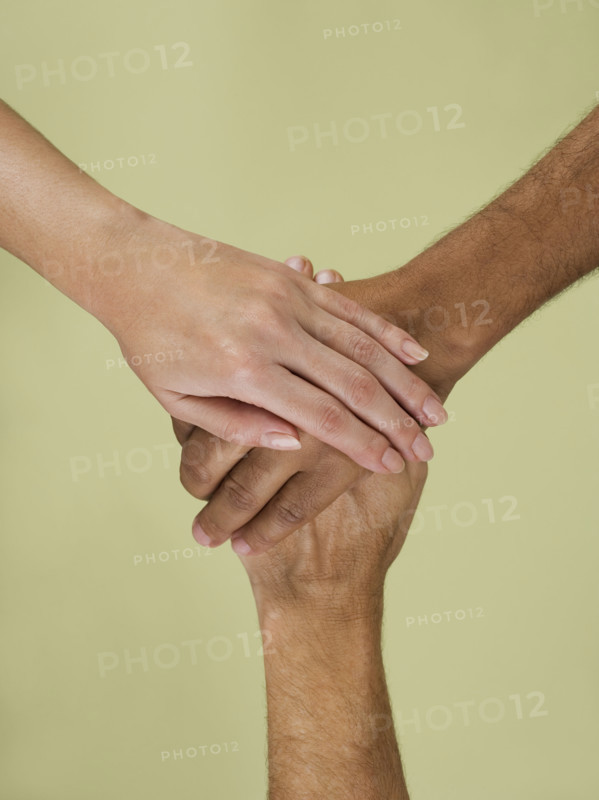Holding hands in multiracial group.
