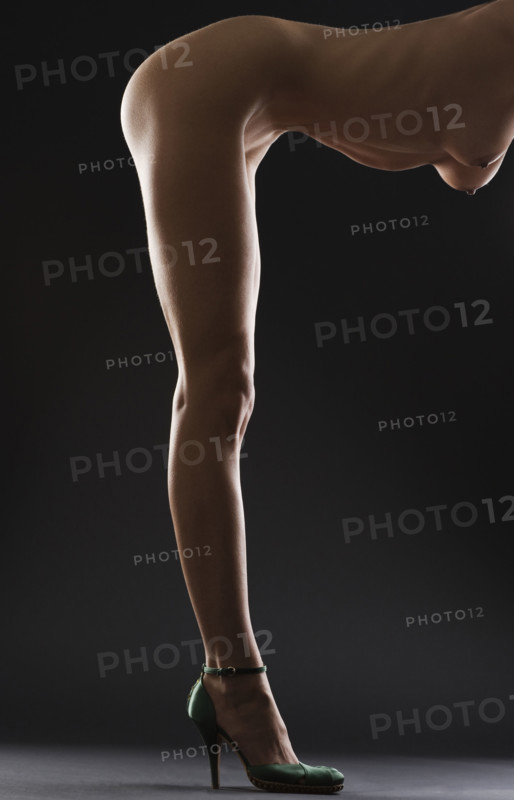 Nude female wearing heels.