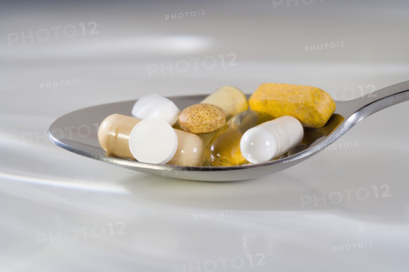 Still life of a spoonful of pills.