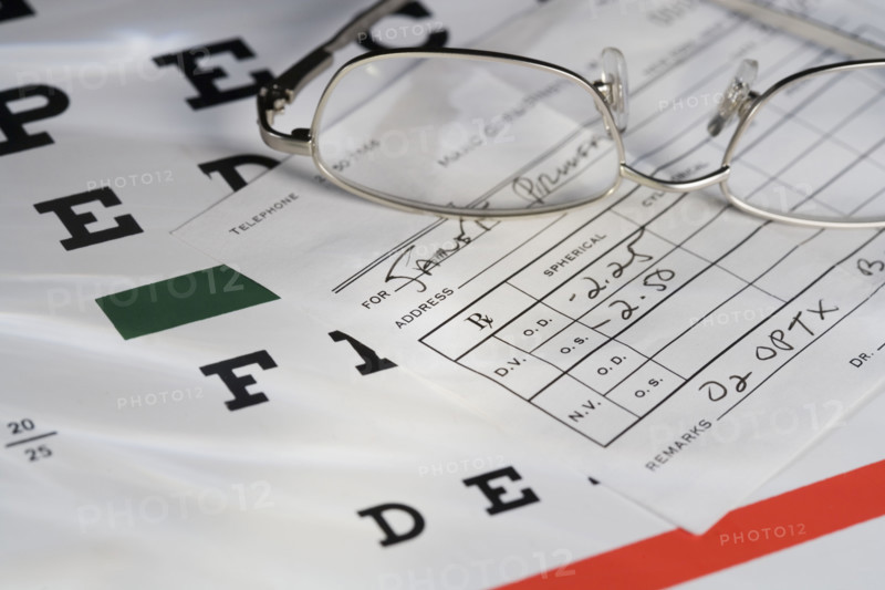 Still life of eye chart and glasses.