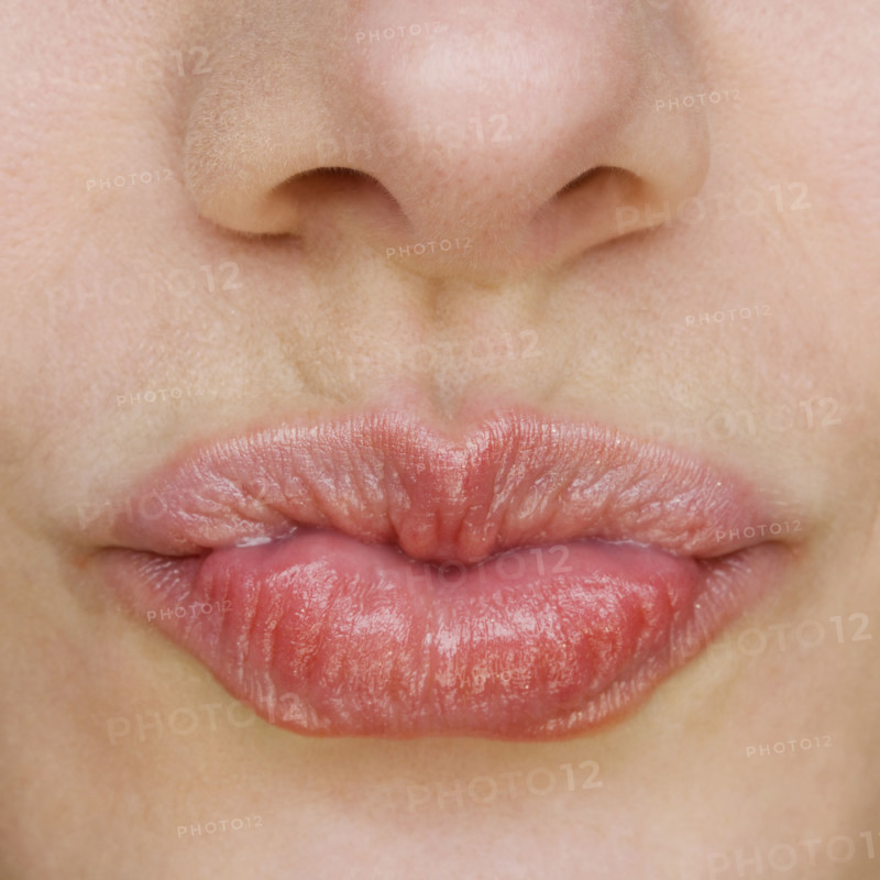 Close up of puckered lips.