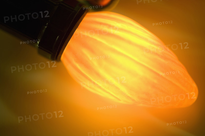 Closeup of a glowing Christmas light bulb.