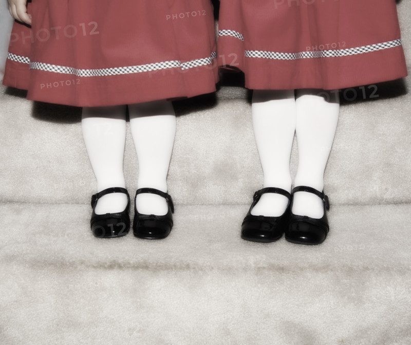 Feet and legs of two girls.