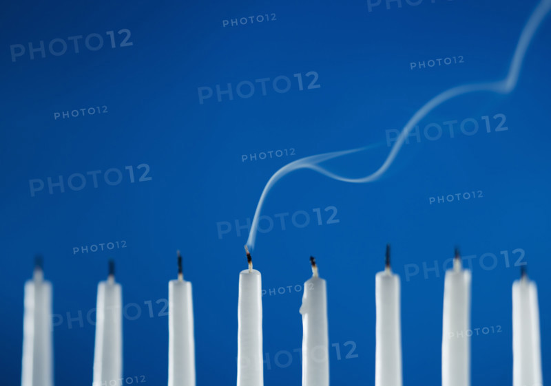 Extinguished candles in a menorah.