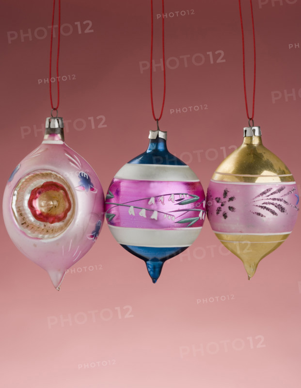 Three hanging Christmas ornanaments.