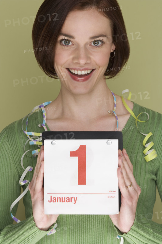Woman holding calendar on first day of the year.