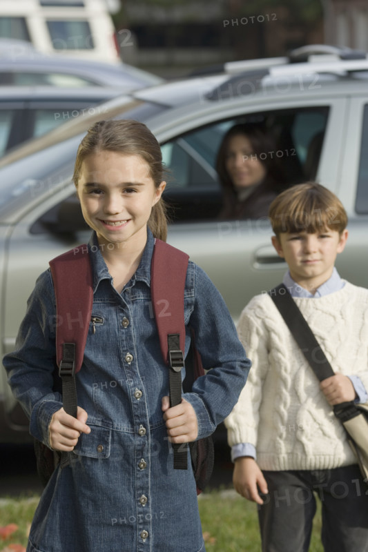 Mother dropping children off at school.
