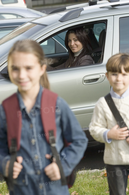 Mother dropping children off at school.