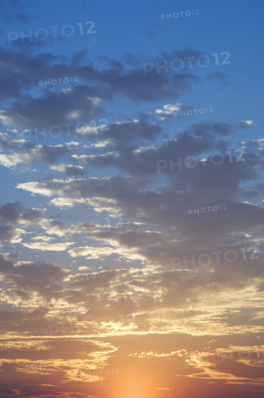 Sunset with puffy clouds.