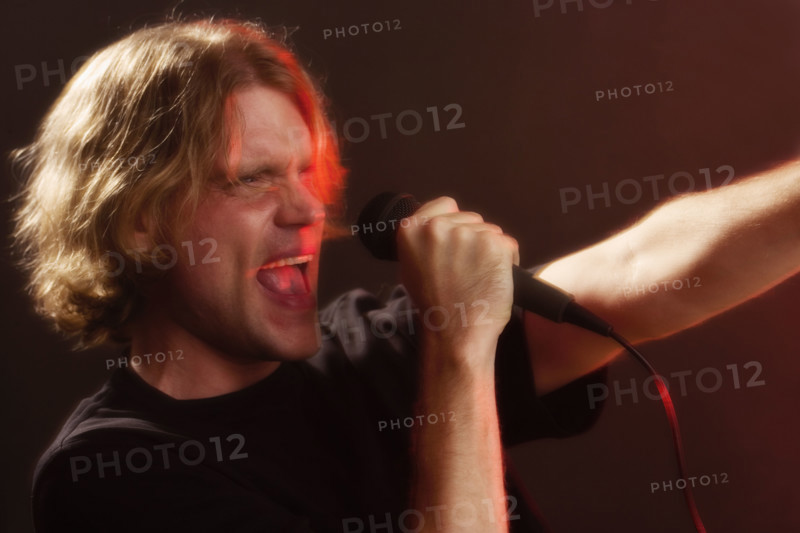 Man singing into microphone.