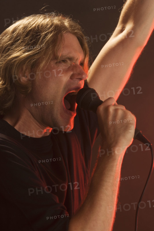 Man singing into microphone.